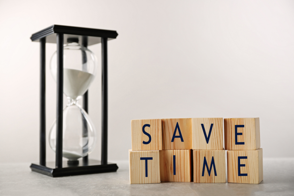 A sand timer and building blocks with letters on them that spell out, "Save Time"